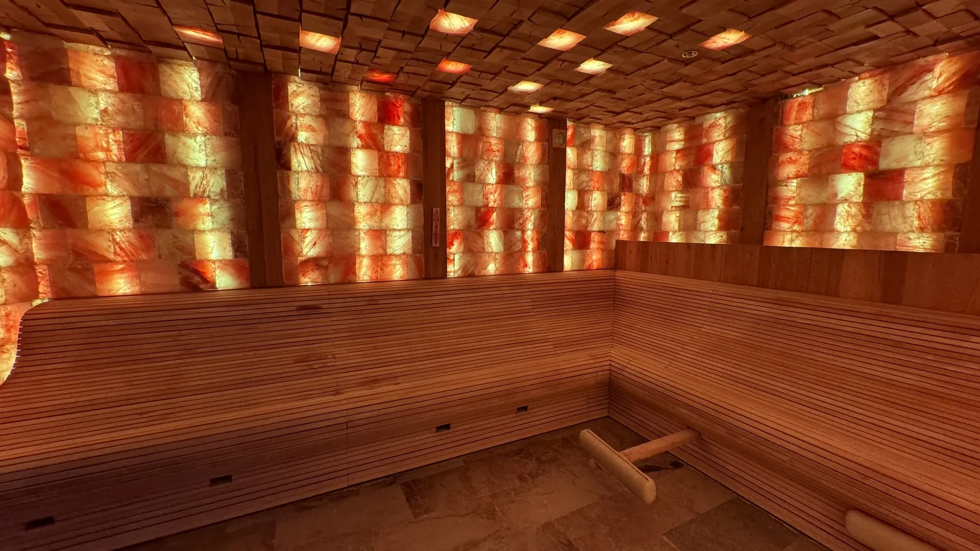 Salzsauna im Deep Nature Spa Park Allgäu mit hinterleuchteter Salzsteinwand und Holzbänken