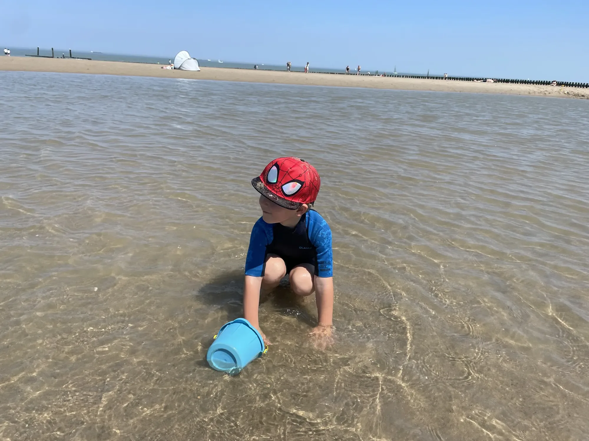 Kind spielt im warmen Prielwasser